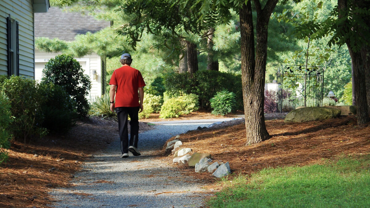 A person walks a pathway at Countryhouse